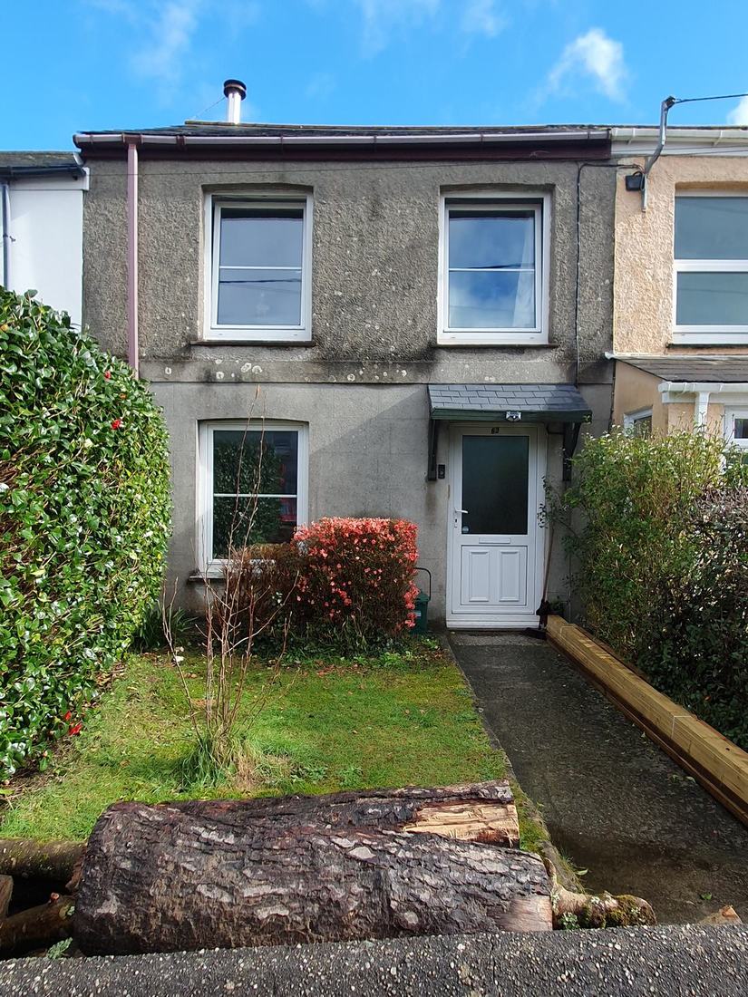A terraced house with a front garden